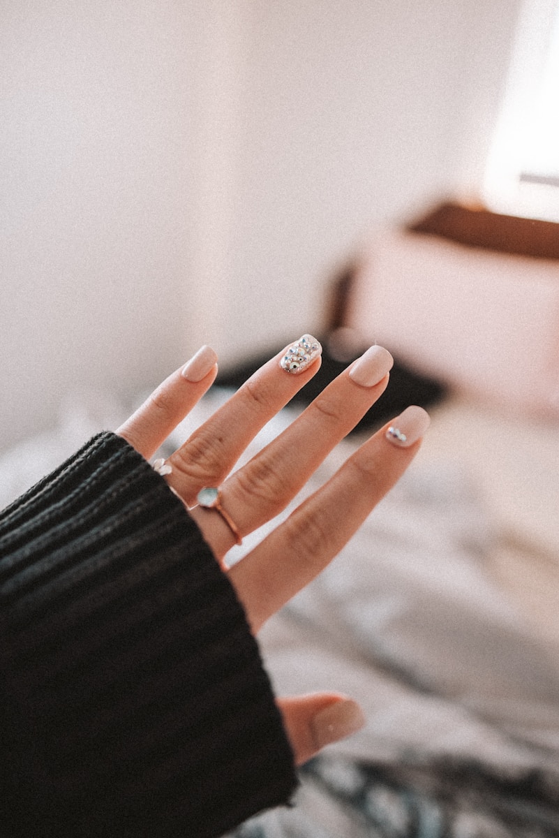 person wearing silver ring and black long sleeve shirt